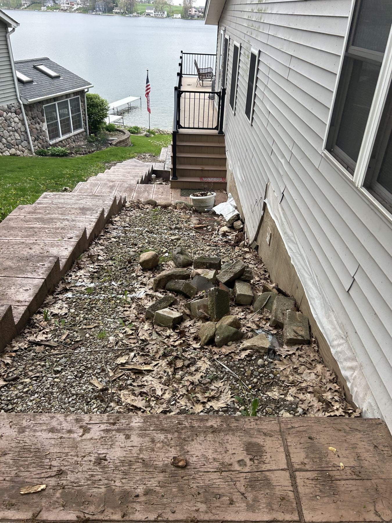 Timber-style concrete steps descending beside a lake home