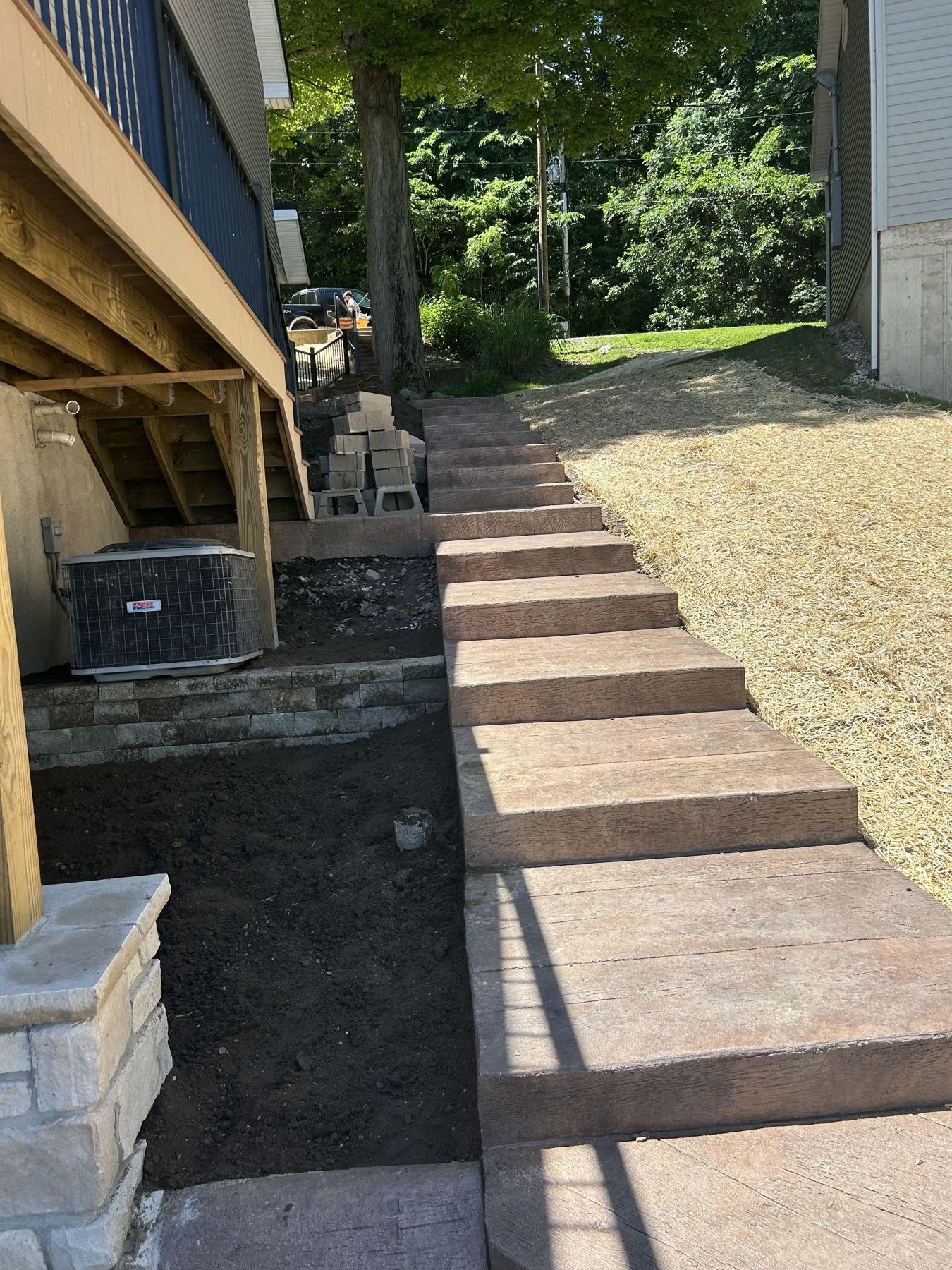 New outdoor steps and stone column under construction